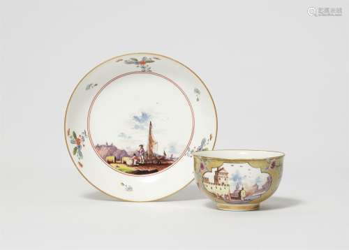 A Meissen porcelain tea bowl and saucer with vedutas and pea...