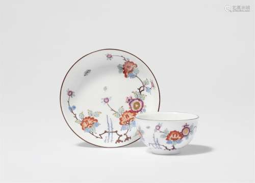 A Meissen porcelain tea bowl and saucer with bamboo and peon...
