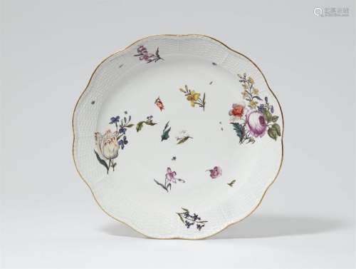 A Meissen porcelain dish from a dinner service painted with ...