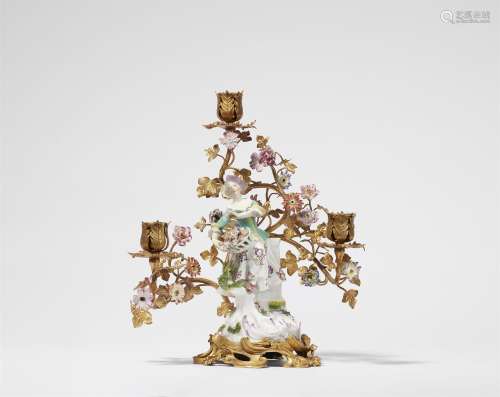 A candelabra with a Meissen porcelain figure of Flora