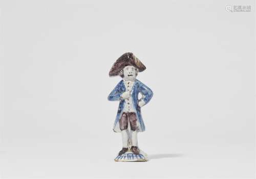 A faience figure of a man in a tricorn hat