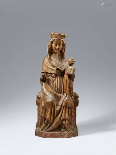 A 14th century carved wood figure of the Madonna enthroned, ...