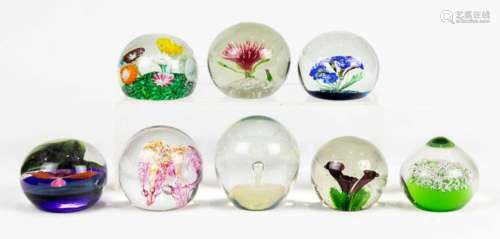 (Lot of 8) Art glass paperweights enclosing flowers or air b...