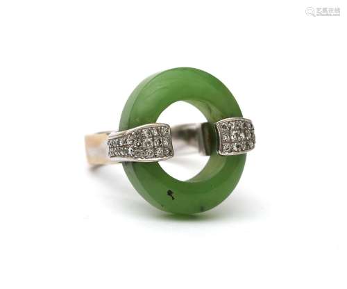 An 18 karat white gold diamond and jade ring. Featuring an o...