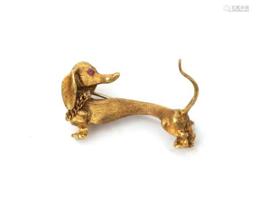 An 18 karat gold dachshund brooch, ca. 1960. The eyes are se...
