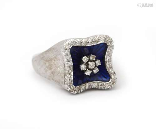 An 18 karat white gold diamond and enamel ring. Featuring a ...