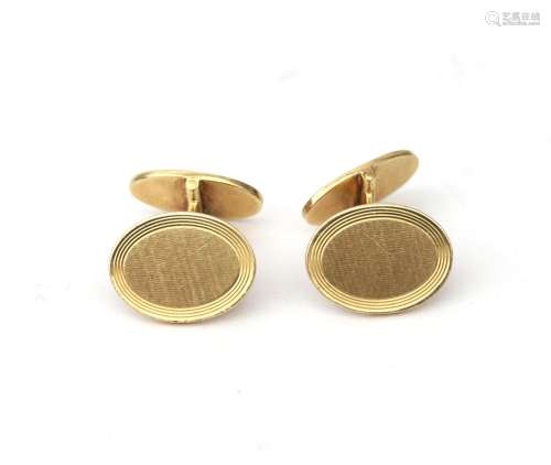 A pair of 14 karat gold cuff links. Of oval design and partl...