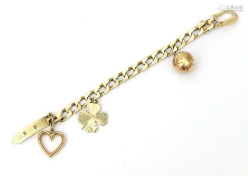 A 14 karat gold charm bracelet. Twisted link bracelet with t...