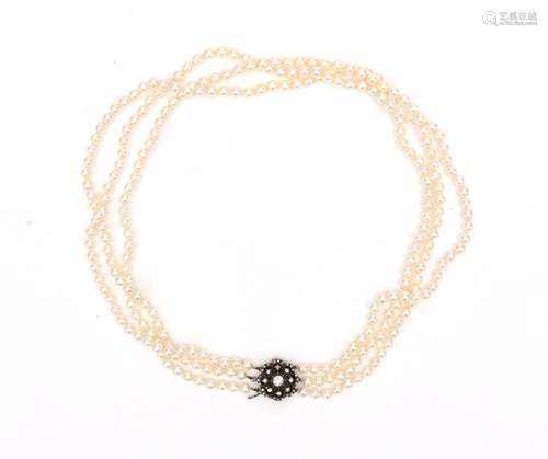 A cultured pearl necklace to a 14 karat gold and silver rose...