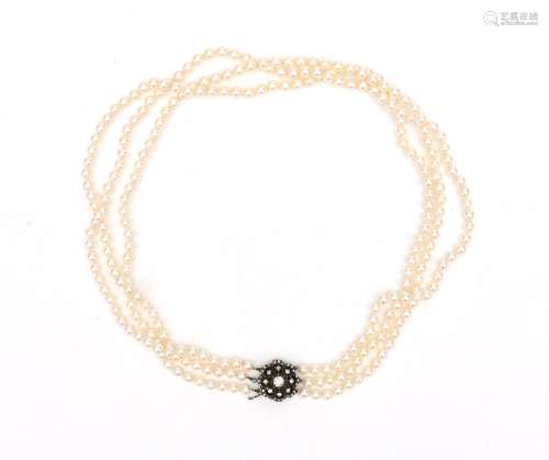 A cultured pearl necklace to a 14 karat gold and silver rose...