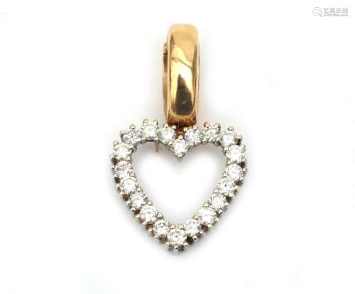 A 14 karat gold diamond set heart shaped pendant. Featuring ...