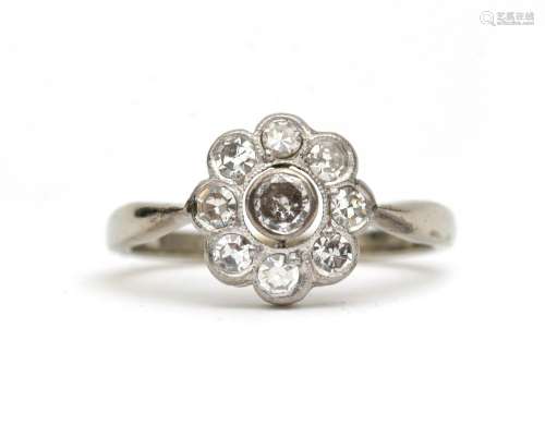 A 14 karat white gold diamond cluster ring. Featuring eight ...