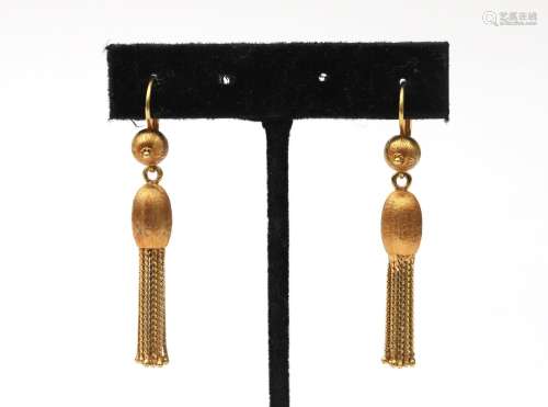 A pair of 18 karat gold tassel earrings. Featuring a ribbed ...
