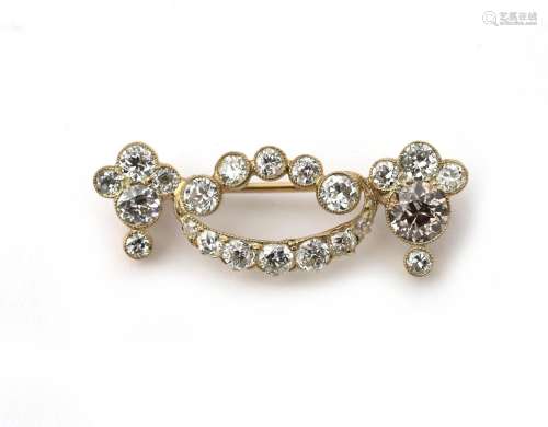 A 14 karat gold diamond festoon brooch. Featuring brilliant ...
