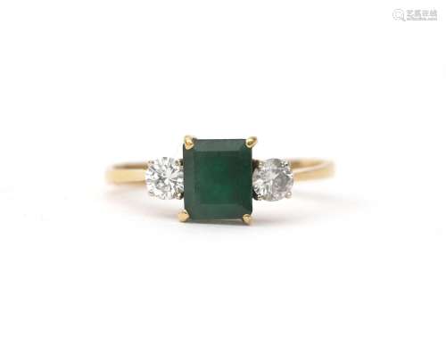 An 18 karat gold emerald and diamond ring. Featuring a step ...