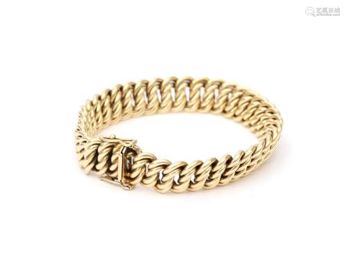 A 14 karat gold bracelet. A double twisted link to a tongue ...
