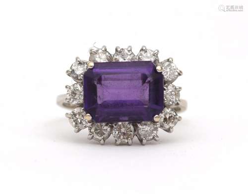 An 18 karat white gold amethyst and diamond cluster ring. Fe...