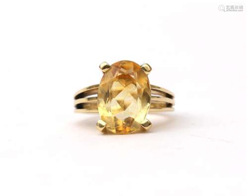 An 18 karat gold ring with citrine, ca. 1950. Featuring a ov...