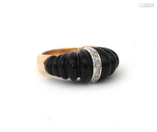 A 14 karat gold onyx and diamond cocktail ring. a domed desi...