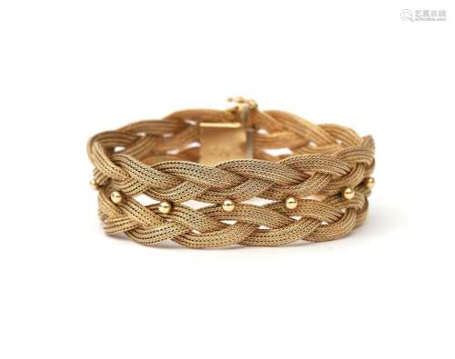 An 18 karat gold braided link bracelet. Two braided rows con...