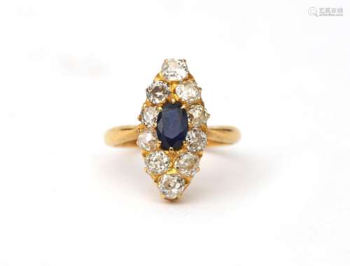An 18 karat gold diamond and sapphire navette ring. Featurin...