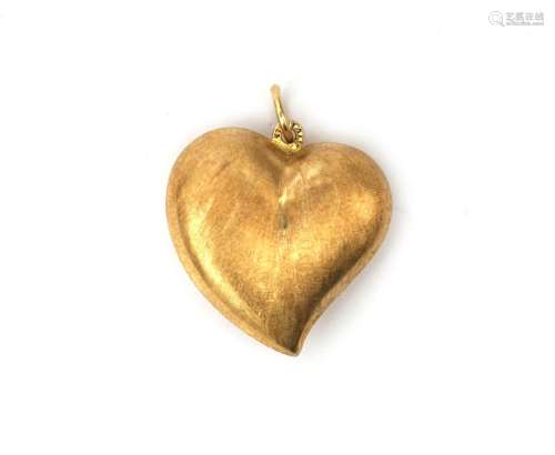 An 14 karat gold heart shaped pendant. The hanger is made in...