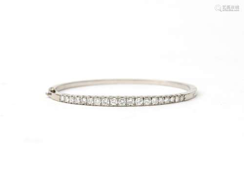 An 18 karat white gold diamond bangle, by Burnier. Featuring...
