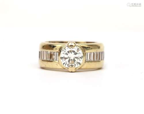 A two tone brilliant and baguette cut diamond ring. Featurin...