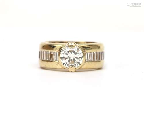 A two tone brilliant and baguette cut diamond ring. Featurin...