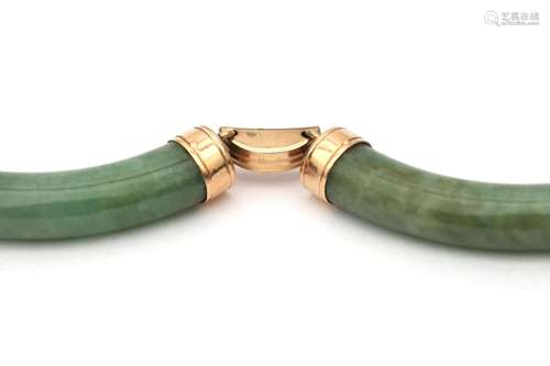 A pair of jadeite earrings and bracelet. In rose gold mounts...