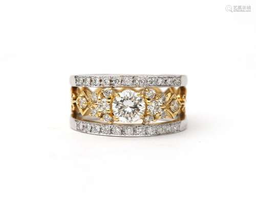 An 18 karat gold two tone diamond band ring. Composed of two...