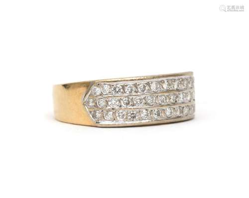 An 18 karat two tone gold diamond ring. A wide band feauturi...