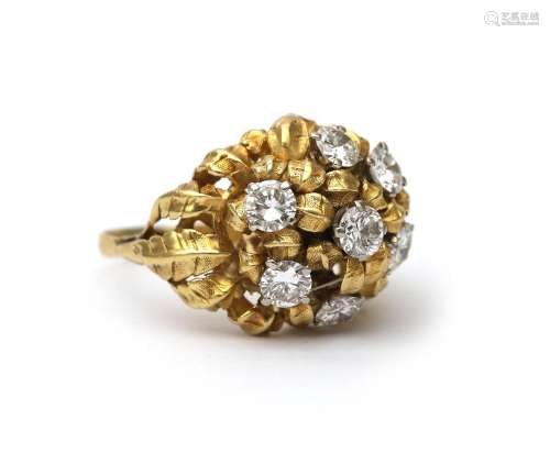 An 18 karat gold diamond bombé ring. A floral open work desi...