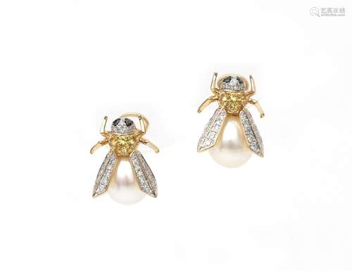 A pair of 14 karat diamond and pearl fly earrings. White gol...