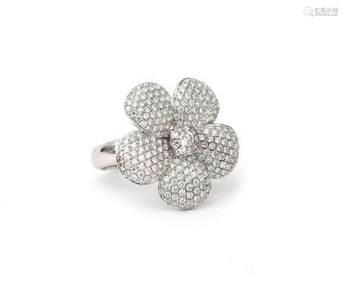 An 18 karat white gold diamond flower ring. A stylized desig...