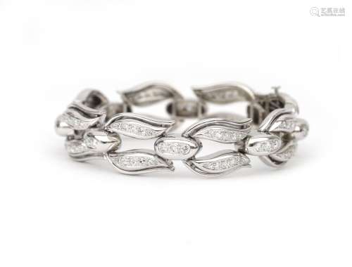 An 18 karat white gold diamond link bracelet. Designed as tu...