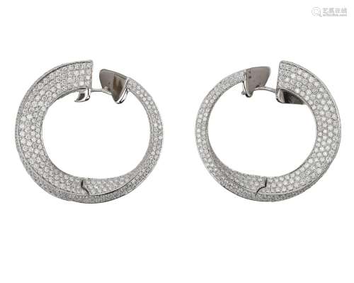 A pair of 18 karat white gold twist earrings with diamonds. ...