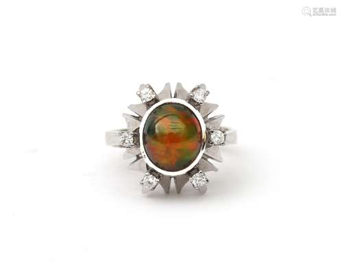 An 18 karat white gold opal and diamond ring. Featuring a ca...