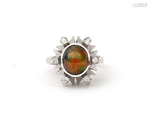 An 18 karat white gold opal and diamond ring. Featuring a ca...
