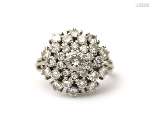 A 14 karat white gold diamond cluster ring. Featuring with a...