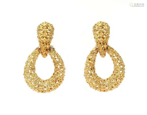 A pair of gold door knocker earrings. Of open openwork pierc...