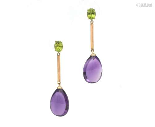 A pair of 14 karat gold amethyst and peridot earrings. Desig...