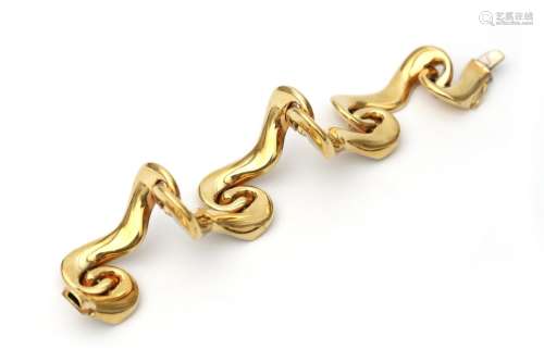 A 14 karat gold scroll work bracelet. Composed of scroll wor...