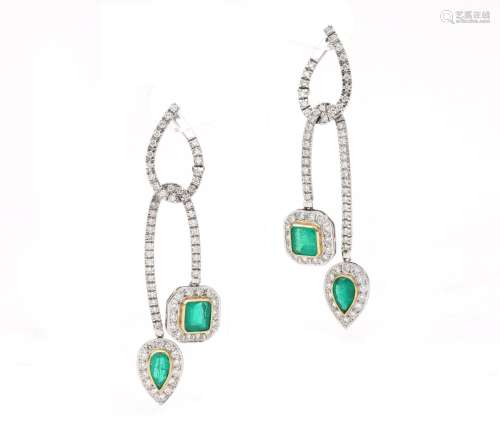 A pair of 18 karat white gold earrings with diamond and emer...