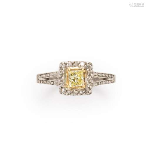 A yellow diamond, diamond and fourteen karat white gold ring