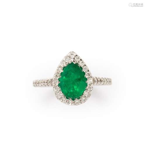 An emerald, diamond and fourteen karat white gold ring