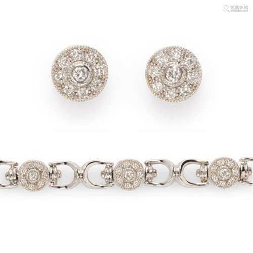 A diamond and eighteen karat white gold bracelet and earring...