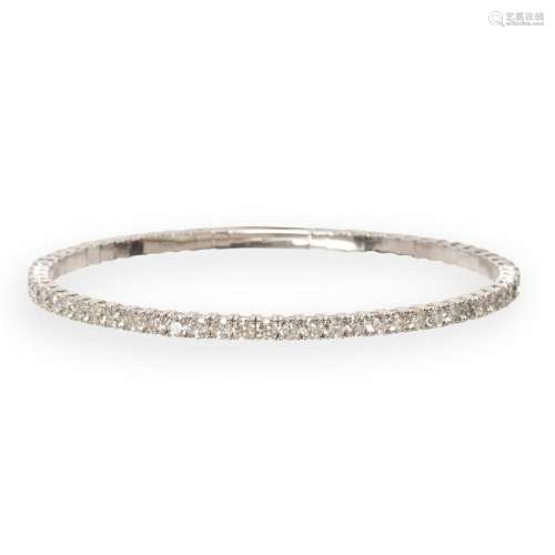 A diamond and fourteen karat white gold bangle bracelet
