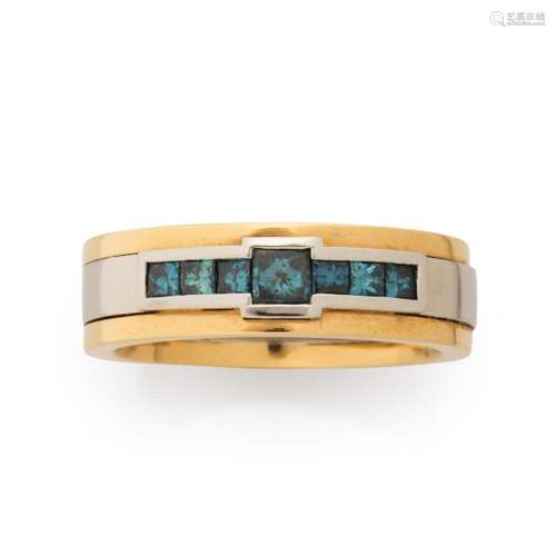 A blue diamond and eighteen karat bi-color gold ring