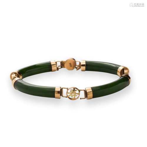 A jade and fourteen karat gold bracelet